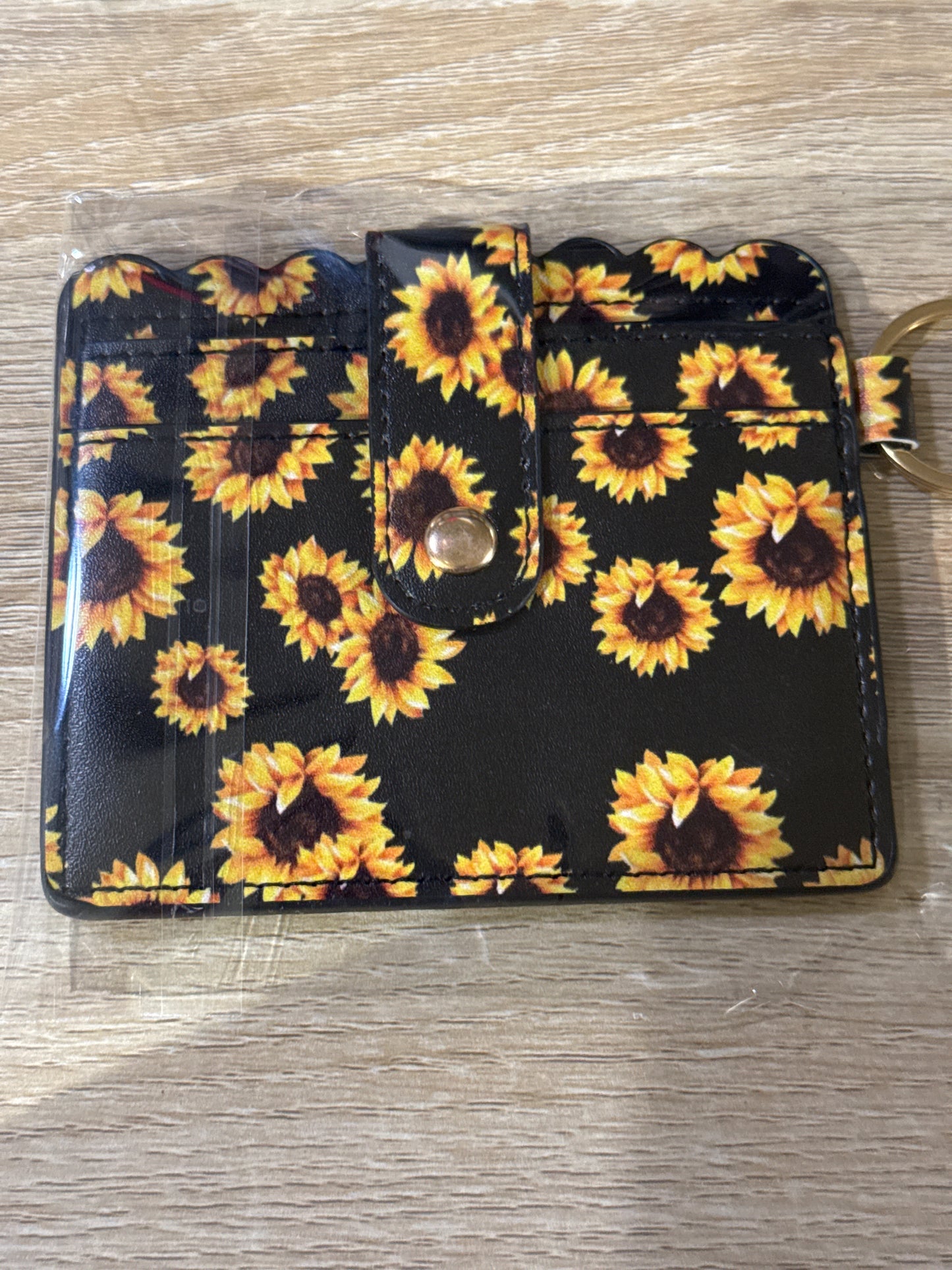 Cartera para tarjetas con diseño de girasol y herrajes dorados